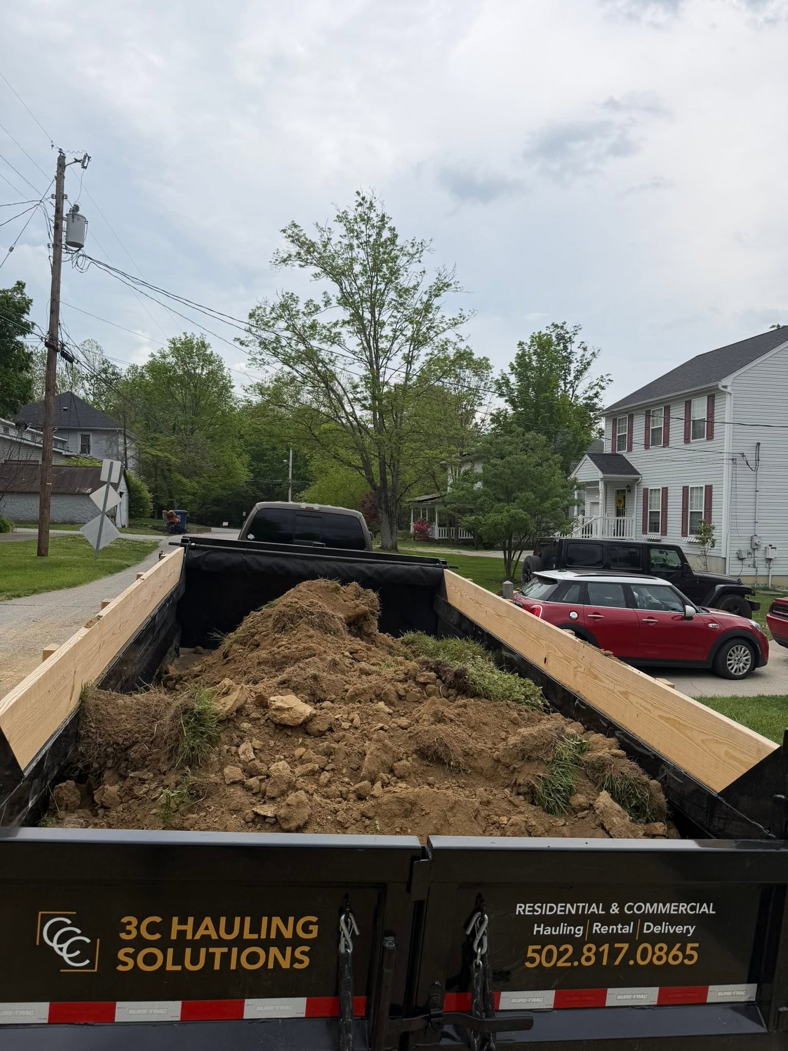 Yard waste and debris hauling in Louisville KY neighborhood — 3C Hauling Solutions